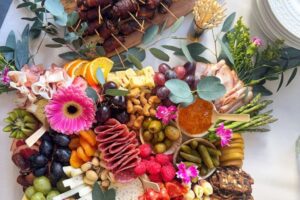 Charcuterie board and bacon wrapped skewers