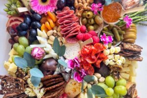 Close up of medium charcuterie board with edible flowers